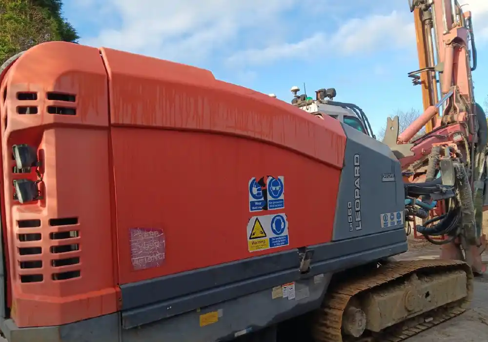Red Sandvik D550 Leopard drill rig on crawler tracks, viewed from close range. | Sandvik